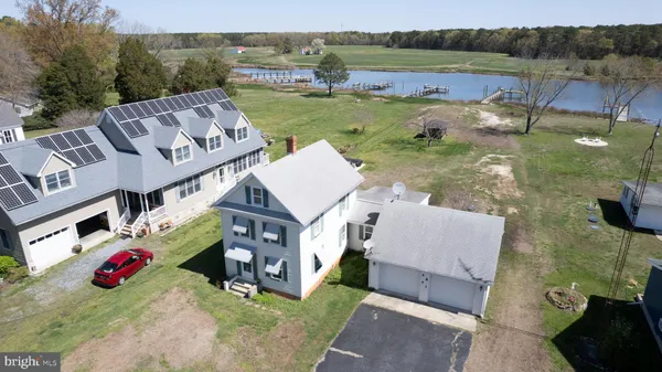 an aerial view of a house with garden space and lake view