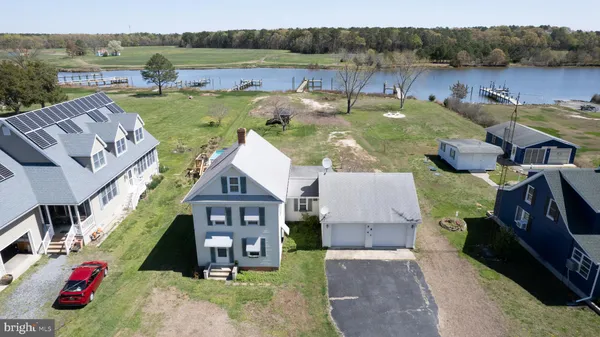 an aerial view of a house with garden space and lake view