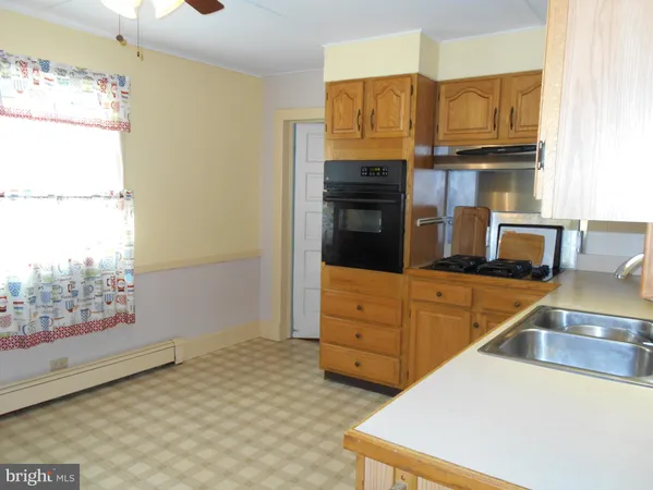 a kitchen with stainless steel appliances granite countertop a sink and a stove