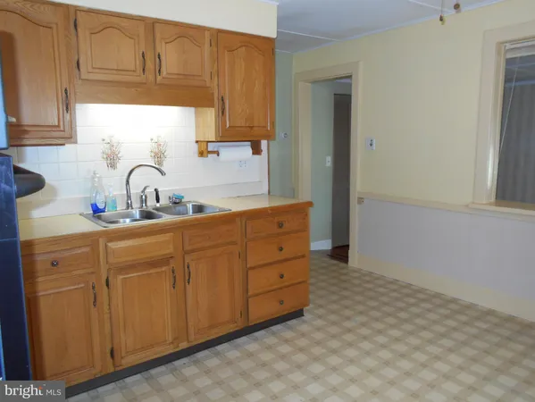 a kitchen with cabinets appliances and a sink