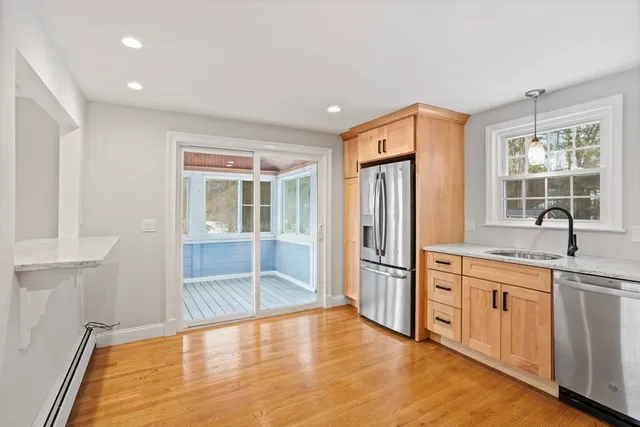 a large kitchen with stainless steel appliances granite countertop a refrigerator and a sink