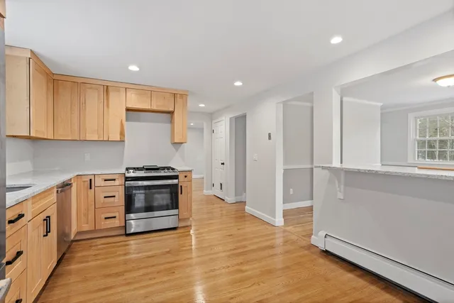a kitchen with stainless steel appliances granite countertop a stove and a refrigerator