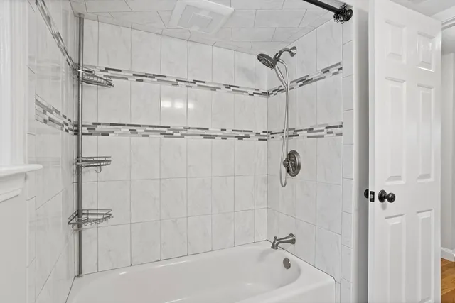 a bathroom with a shower and a bathtub