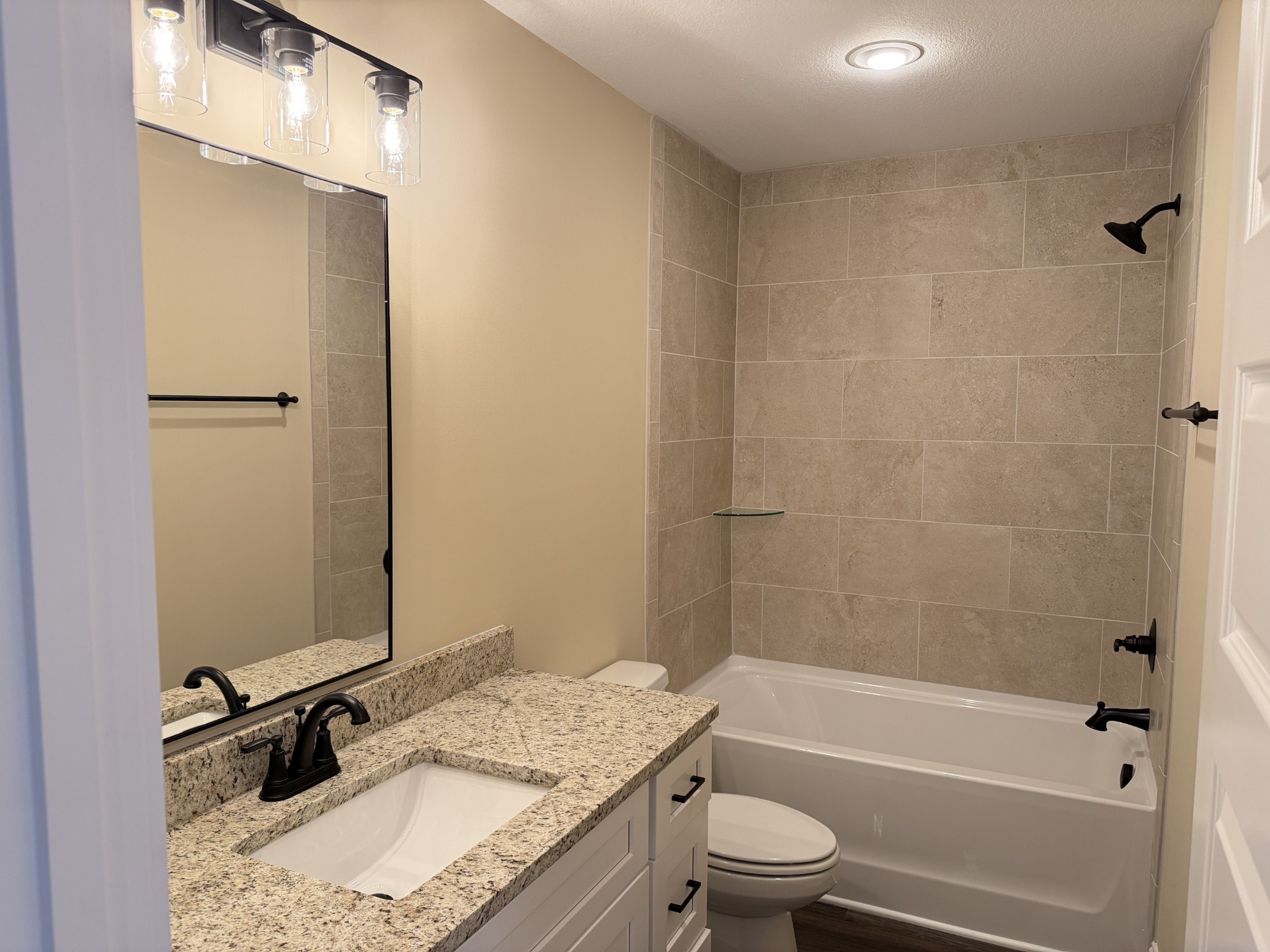 128 Hummingbird Way Clarksville, TN 37043 - Photo 18 of 19 a bathroom with a granite countertop sink toilet and shower