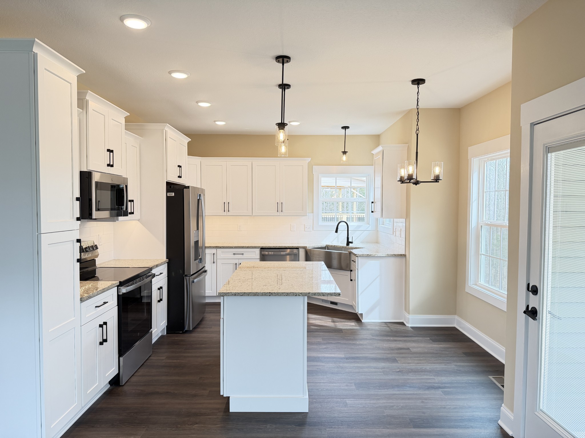 128 Hummingbird Way Clarksville, TN 37043 - Photo 2 of 19 a large kitchen with white cabinets and stainless steel appliances