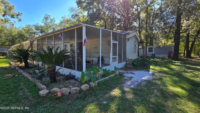 a view of a house with a yard and garden