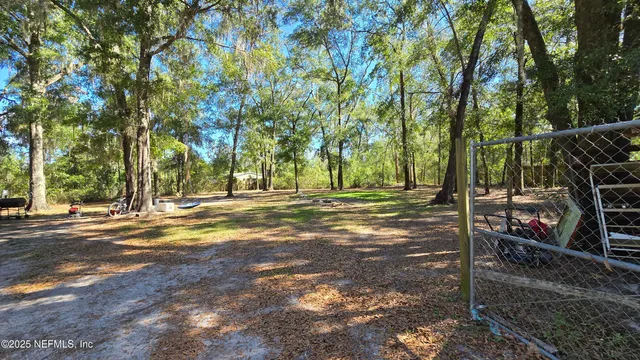 a view of a yard with basketball court
