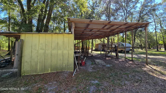 a view of a backyard with plants and a backyard