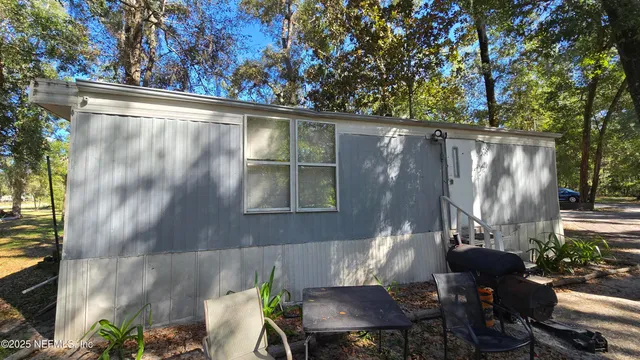 a backyard of a house with outdoor seating