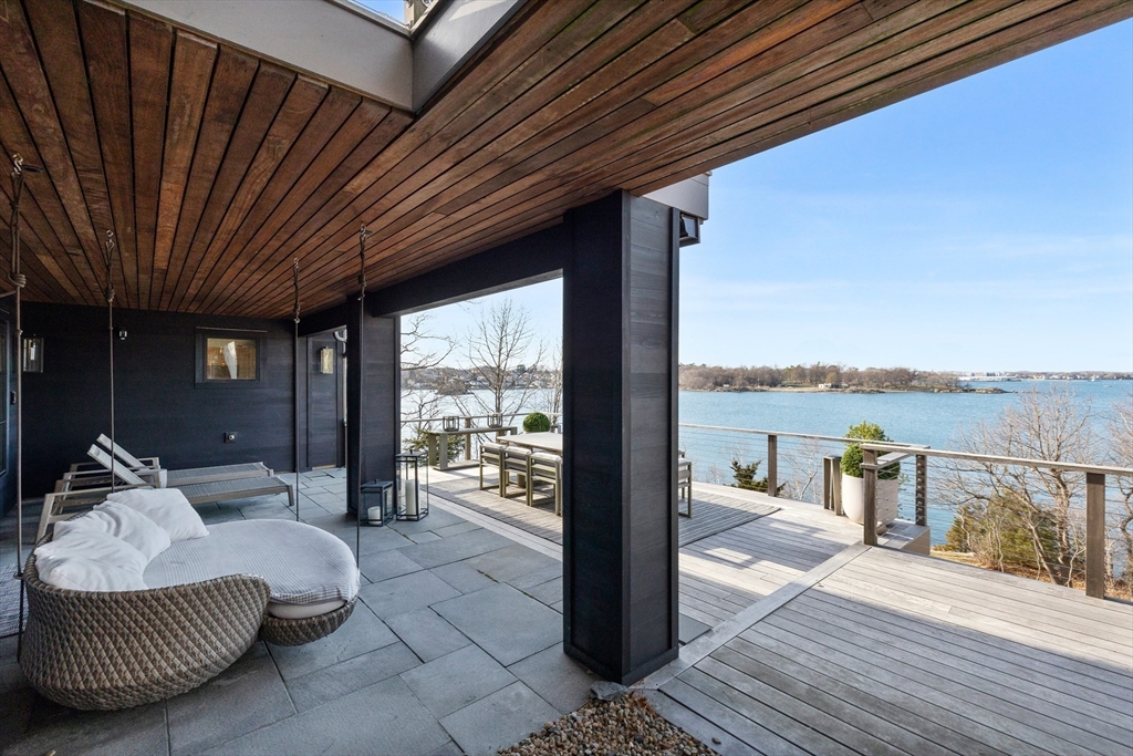 23 Pinecliff Drive Marblehead, MA 01945 - Photo 28 of 41 a balcony with furniture and a floor to ceiling window