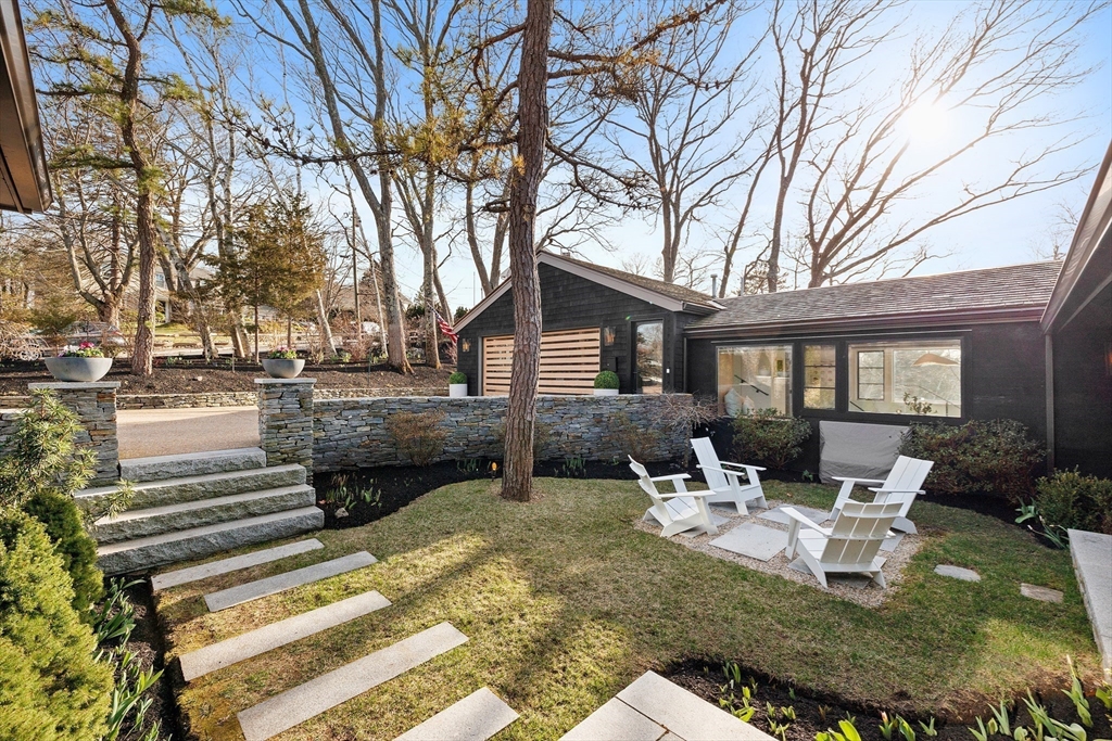 23 Pinecliff Drive Marblehead, MA 01945 - Photo 39 of 41 a view of a patio with table and chairs and potted plants and large tree