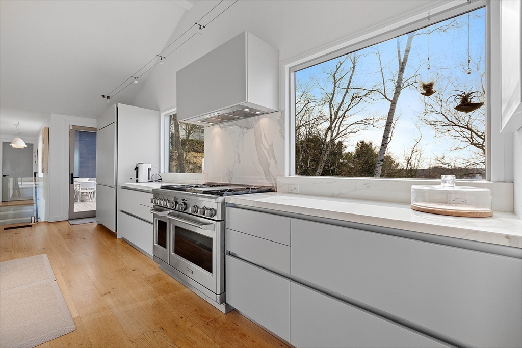 23 Pinecliff Drive Marblehead, MA 01945 - Photo 5 of 41 a kitchen with stainless steel appliances granite countertop a stove and a white refrigerator