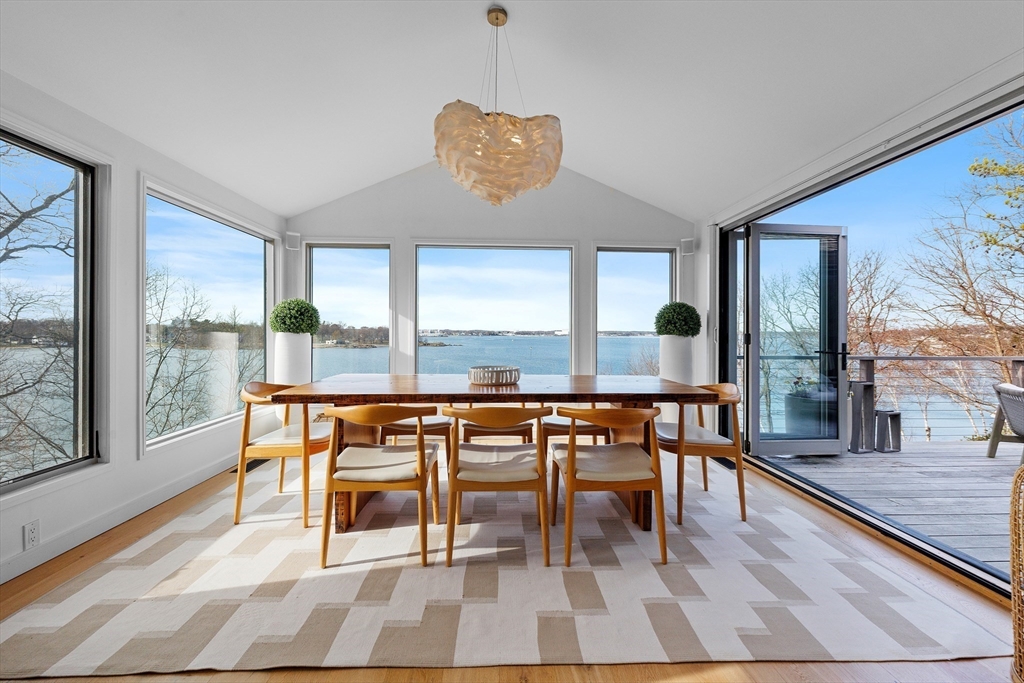 23 Pinecliff Drive Marblehead, MA 01945 - Photo 8 of 41 a dining room with wooden floor a glass table and chairs