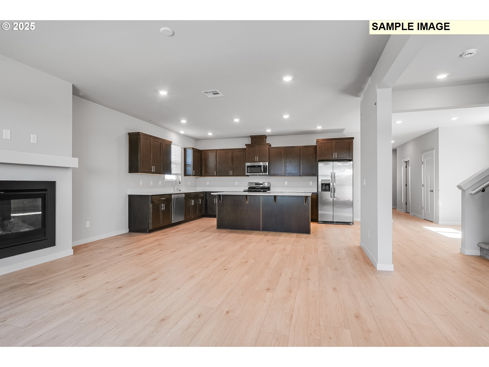 1036 Legacy Street Eugene, OR 97402 - Photo 4 of 18 a large kitchen with cabinets and a wooden floor