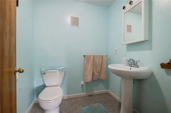 a bathroom with a sink toilet and a mirror