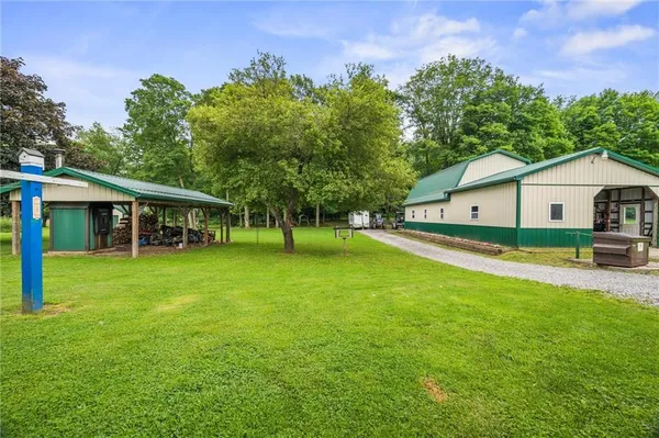 a front view of a house with a yard and trees