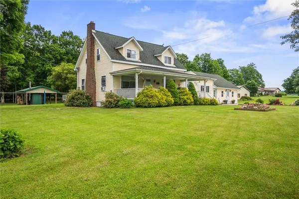 a front view of house with yard and green space
