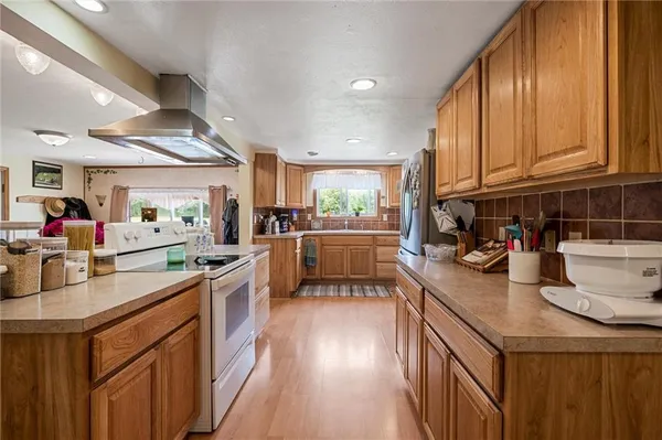 a kitchen with stove cabinets and a sink
