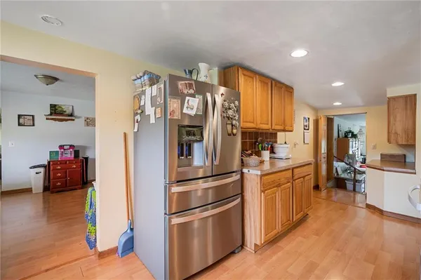 a kitchen with stainless steel appliances granite countertop a refrigerator and a stove top oven
