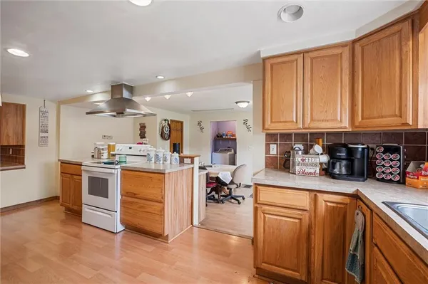 a kitchen with stainless steel appliances granite countertop a lot of counter top space and cabinets