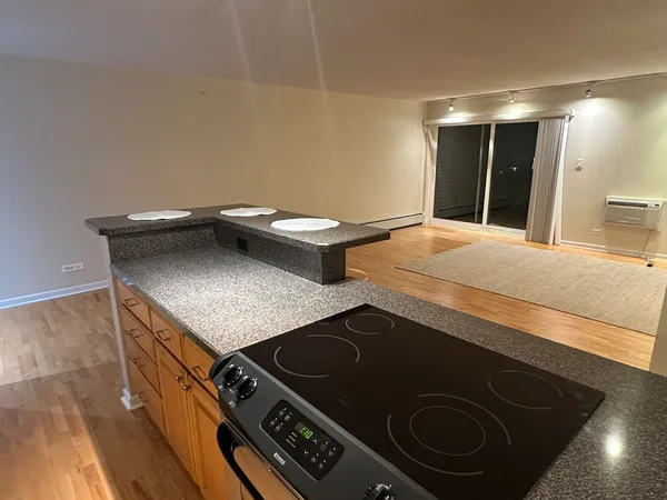 a kitchen with stainless steel appliances wooden cabinets a sink and a stove