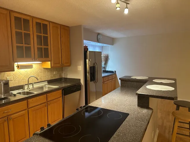 a kitchen with kitchen island a counter top space and a sink