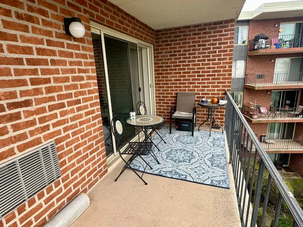 a view of a balcony with furniture