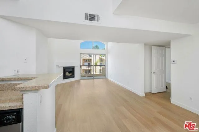 a kitchen with granite countertop a sink and a stove
