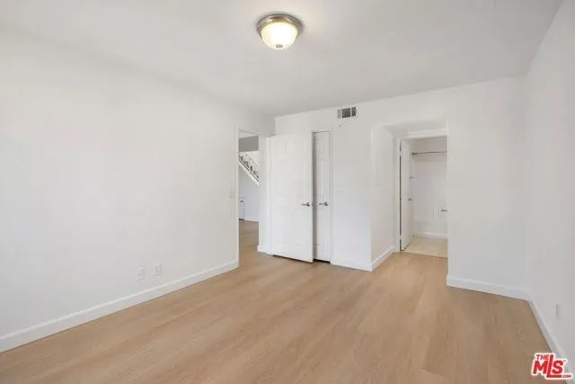 a bathroom with a granite countertop sink mirror vanity and toilet