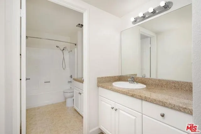 a bedroom with bed and a chandelier