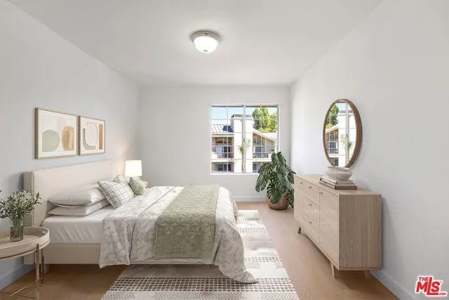 a bathroom with a granite countertop sink a toilet and a mirror