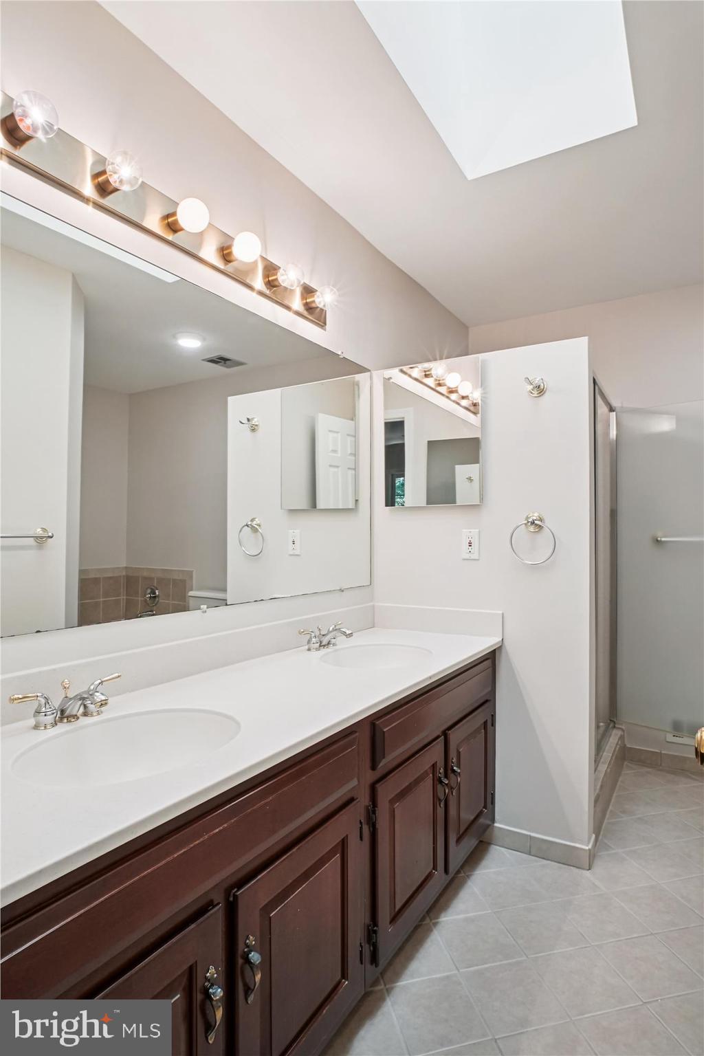 2697 Marcey Road Arlington, VA 22207 - Photo 28 of 64 a spacious bathroom with a granite countertop sink and mirror