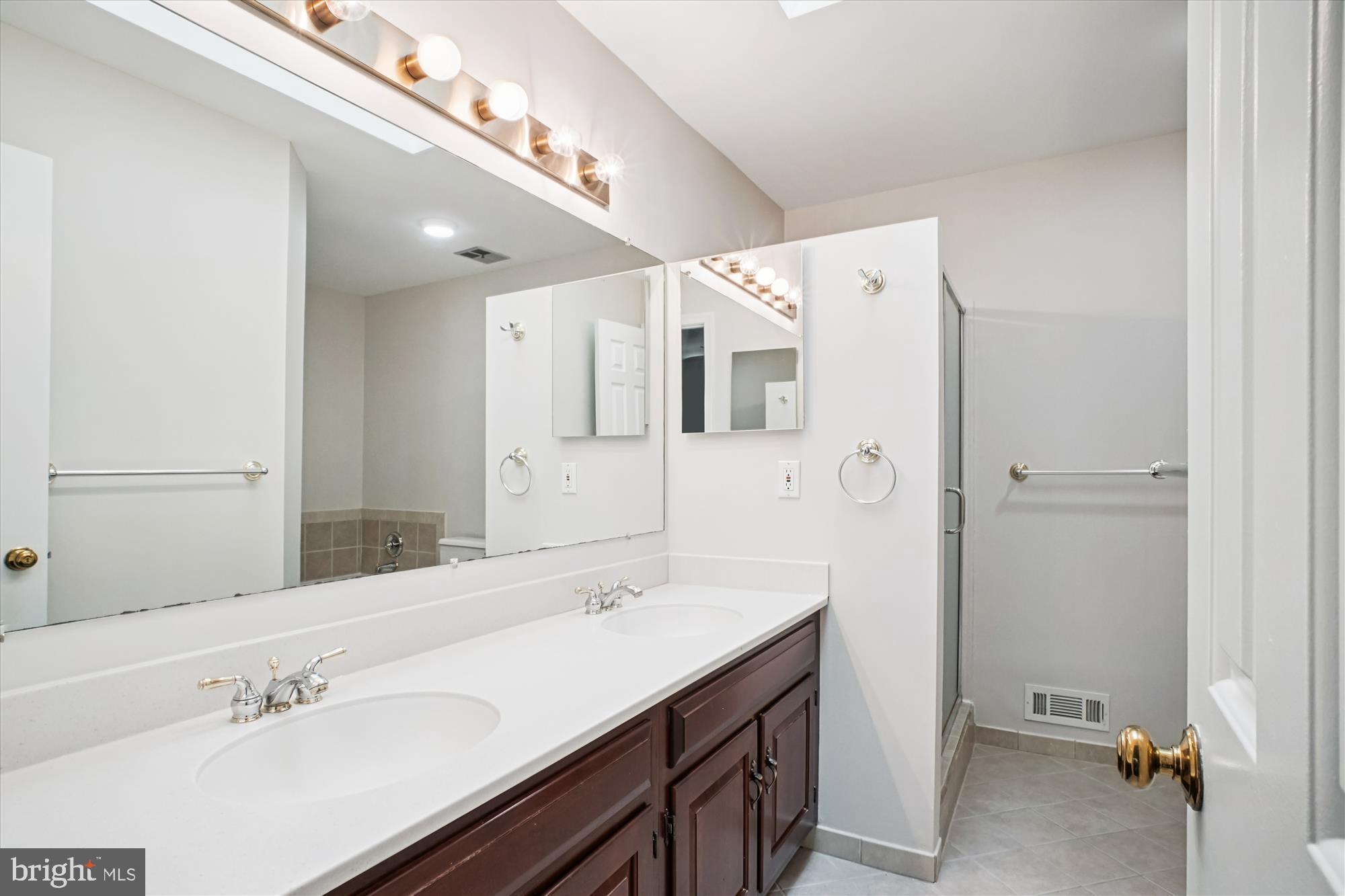 2697 Marcey Road Arlington, VA 22207 - Photo 29 of 64 a spacious bathroom with a sink and a mirror