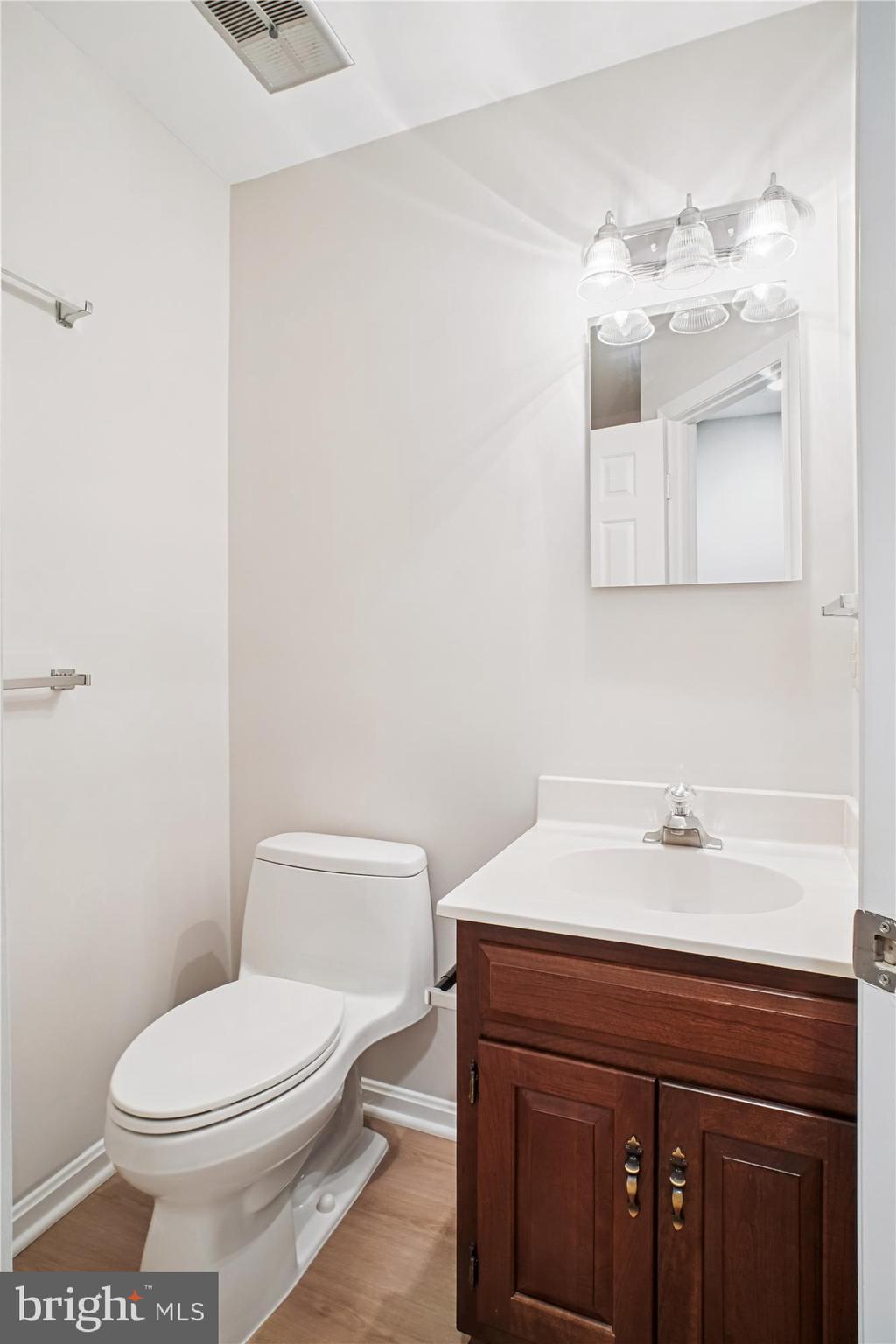 2697 Marcey Road Arlington, VA 22207 - Photo 42 of 64 a bathroom with a sink a toilet and mirror