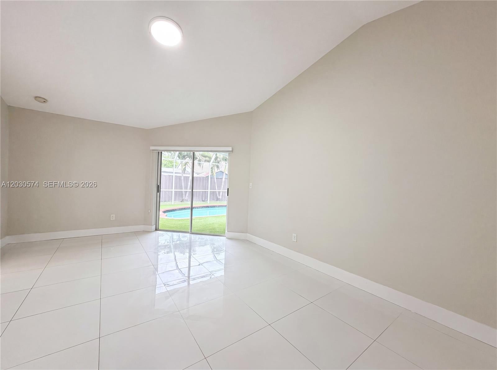 16571 Southwest 145th Avenue Miami, FL 33177 - Photo 9 of 25 an empty room with windows