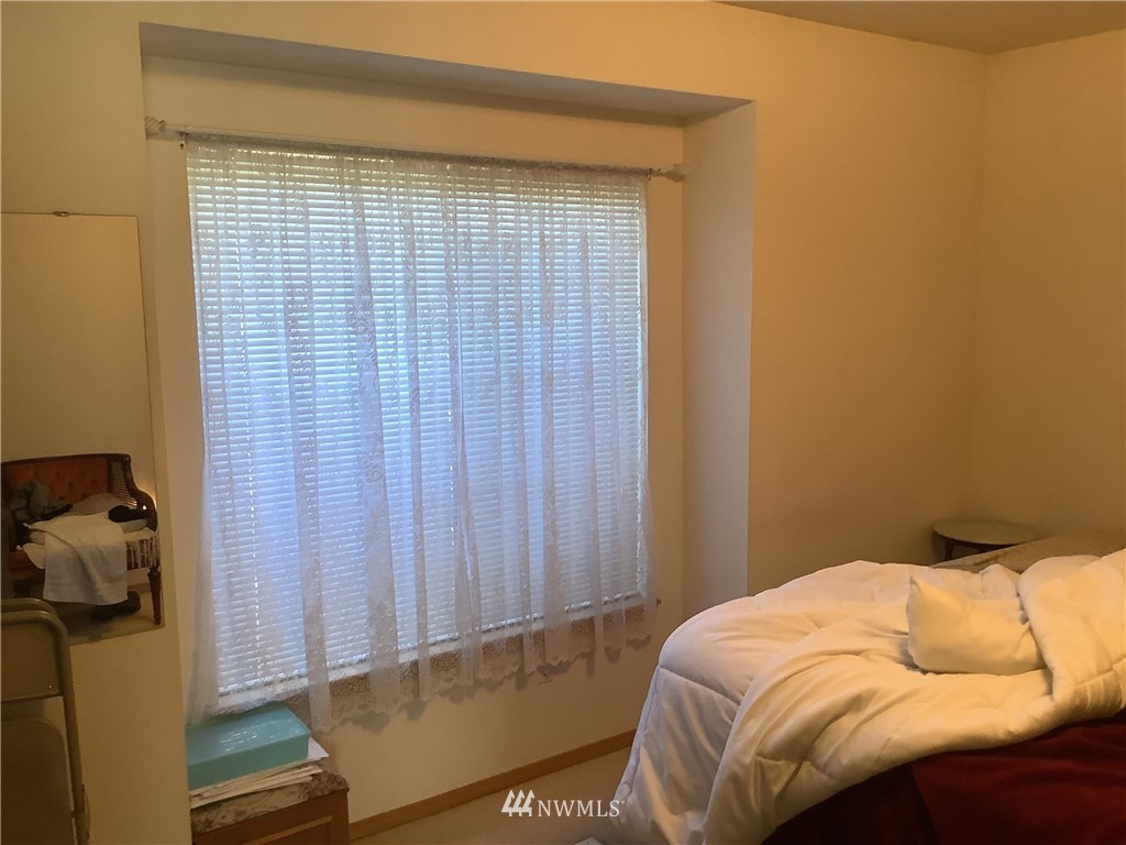 9323 180th Way Southwest Rochester, WA 98579 - Photo 20 of 33 a bedroom with a bed and a window