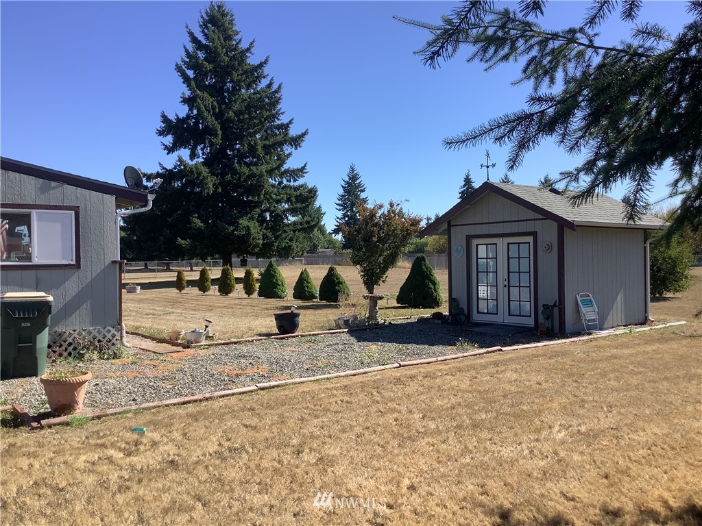9323 180th Way Southwest Rochester, WA 98579 - Photo 26 of 33 a view of a white house with a yard