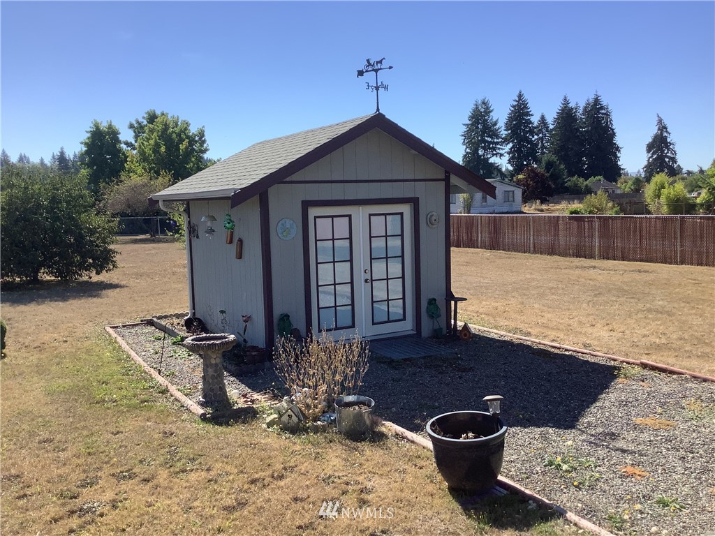 9323 180th Way Southwest Rochester, WA 98579 - Photo 27 of 33 a front view of a house with garden