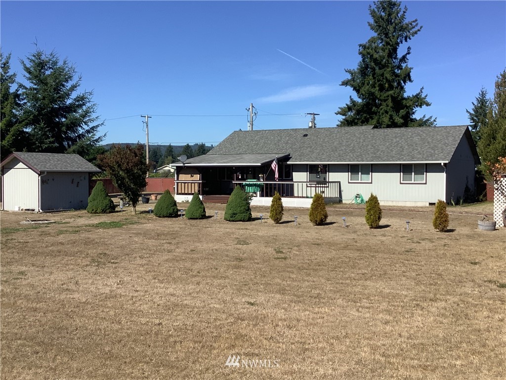 9323 180th Way Southwest Rochester, WA 98579 - Photo 33 of 33 a view of a house with backyard and sitting area