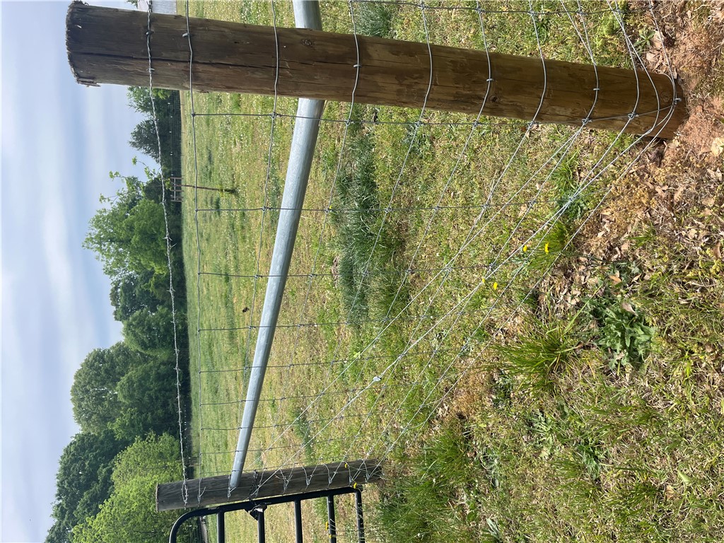 107 Humphrey Wright Road Honea Path, SC 29654 - Photo 5 of 23 An open rural landscape features a fence, ideal for agricultural pursuits or expansive outdoor living.