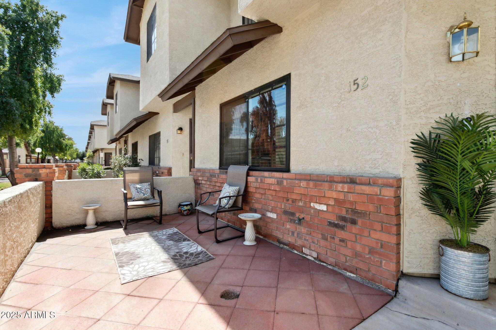 170 East Guadalupe Road, Unit 152 Gilbert, AZ 85234 - Photo 11 of 29 a balcony with furniture and potted plants