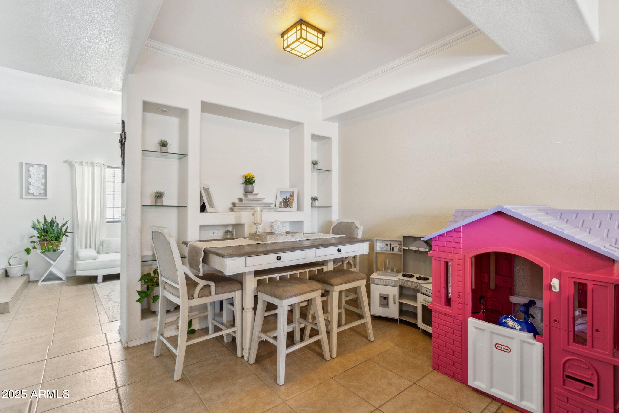 170 East Guadalupe Road, Unit 152 Gilbert, AZ 85234 - Photo 16 of 29 a view of a dining room with furniture and chandelier