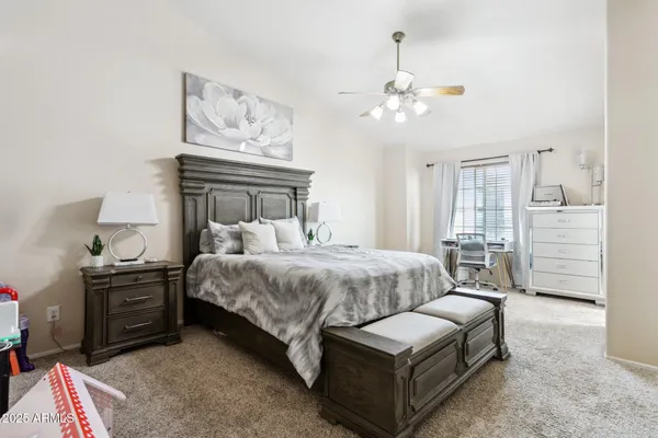 a bedroom with bed and a chandelier