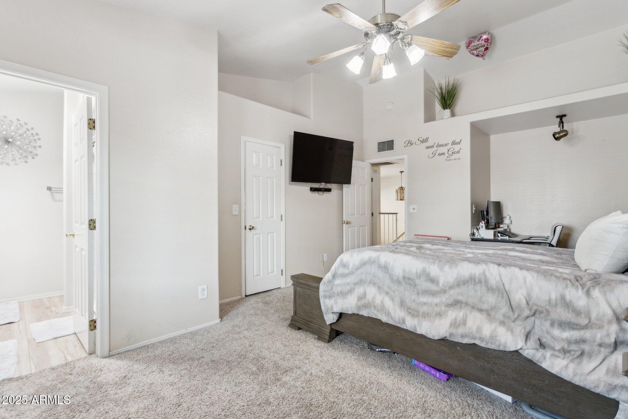 170 East Guadalupe Road, Unit 152 Gilbert, AZ 85234 - Photo 19 of 29 a bedroom with a bed and a flat screen tv