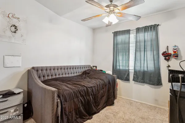 a bed sitting in a bedroom next to a window