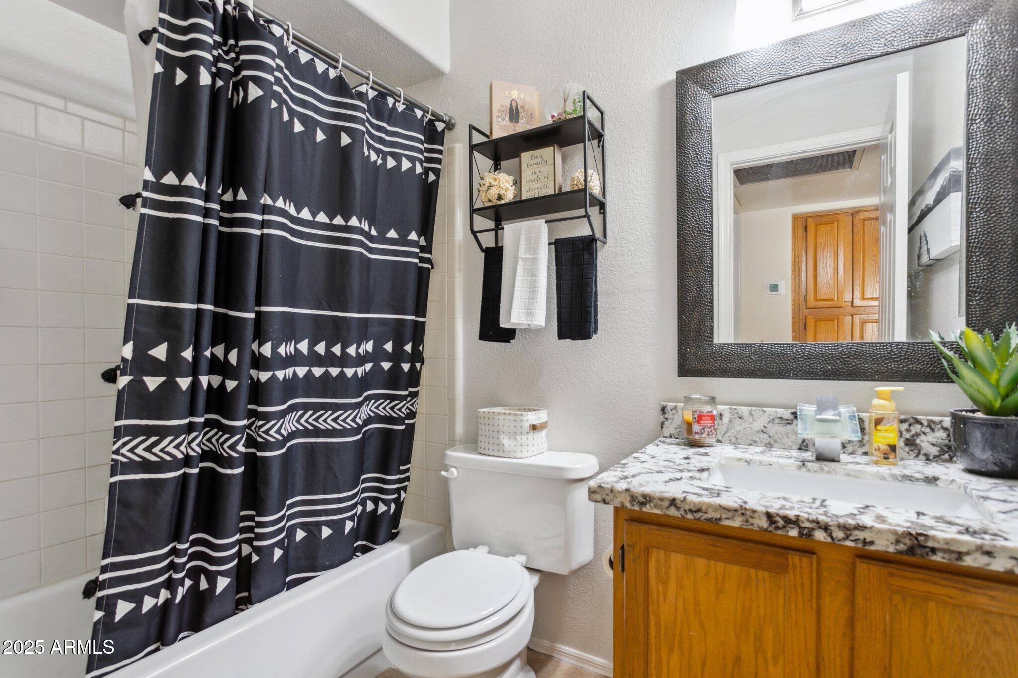 170 East Guadalupe Road, Unit 152 Gilbert, AZ 85234 - Photo 22 of 29 a bathroom with a granite countertop sink toilet and shower