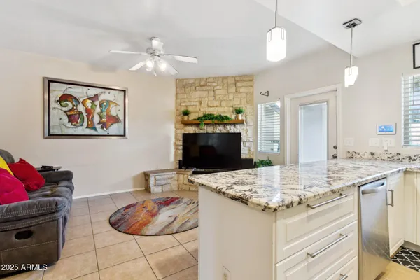 a kitchen with stainless steel appliances granite countertop a sink and a stove