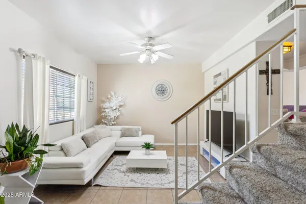 a living room with furniture and a chandelier