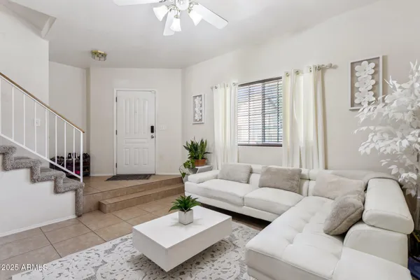 a living room with furniture and wooden floor