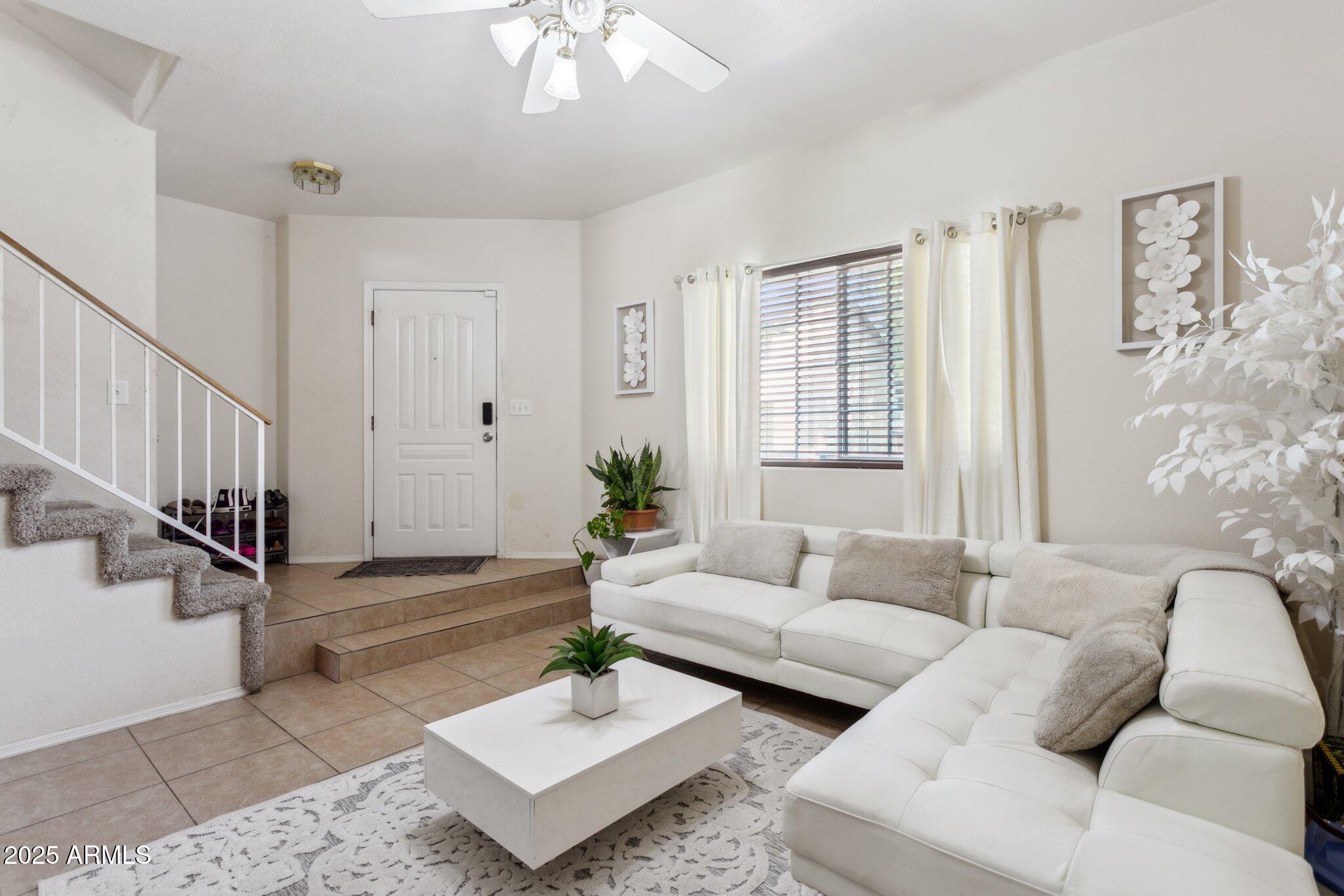 170 East Guadalupe Road, Unit 152 Gilbert, AZ 85234 - Photo 9 of 29 a living room with furniture and wooden floor